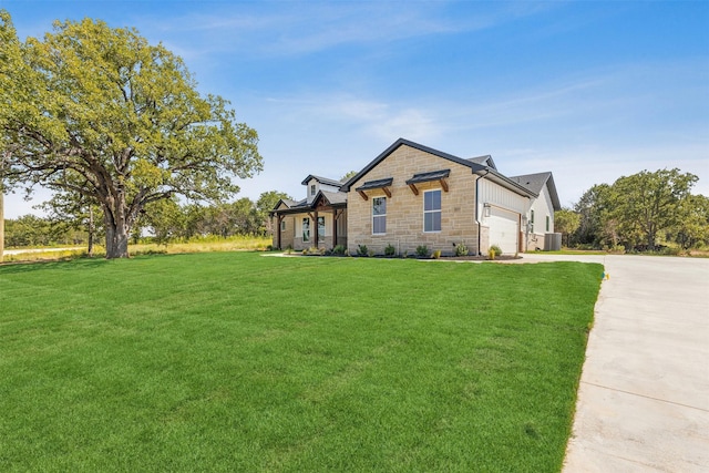 view of front of home with a front yard, a garage, and cooling unit