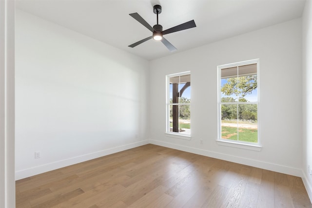 spare room with ceiling fan and light wood-type flooring