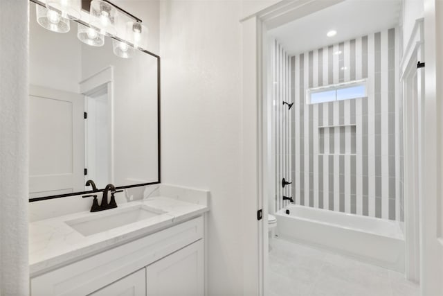 full bathroom featuring tile patterned floors, toilet, vanity, and tiled shower / bath