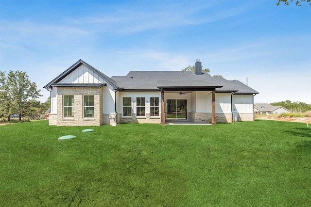 rear view of property with a yard and ceiling fan