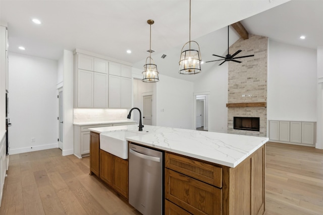 kitchen with white cabinets, stainless steel dishwasher, and a spacious island