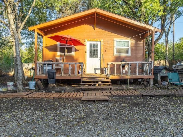 back of property with a wooden deck