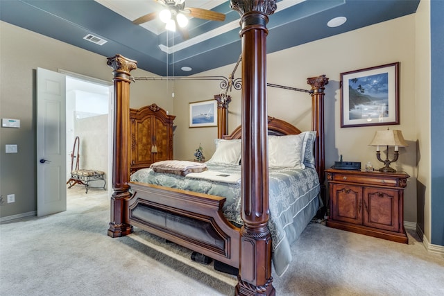 bedroom featuring carpet, ceiling fan, a raised ceiling, and ornamental molding