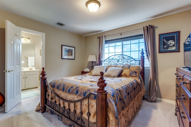 carpeted bedroom featuring ensuite bathroom