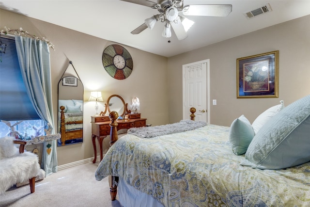 bedroom with ceiling fan and light carpet