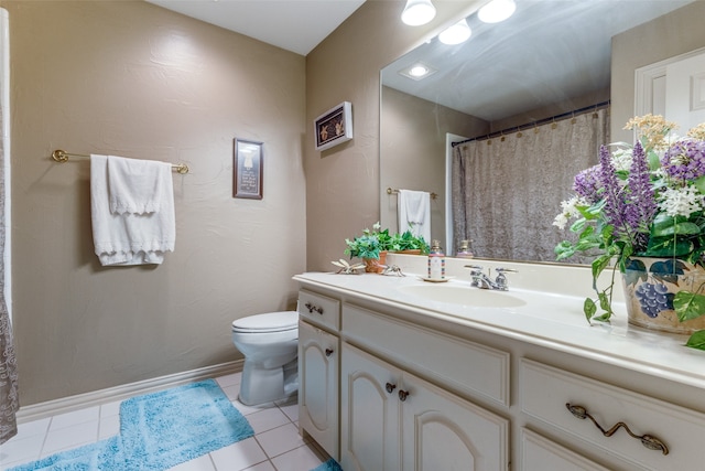 bathroom with tile patterned floors, vanity, and toilet