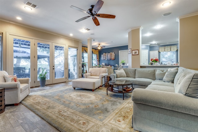 living room with french doors, light wood-type flooring, ceiling fan, and crown molding