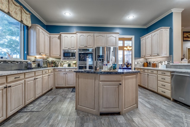 kitchen with a center island, stainless steel appliances, crown molding, and light hardwood / wood-style floors