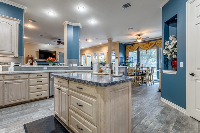 kitchen with hardwood / wood-style flooring, a center island, kitchen peninsula, and crown molding