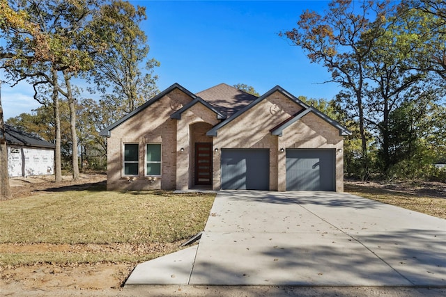 view of front of property featuring a garage and a front lawn