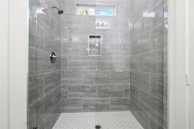 bathroom with a tile shower