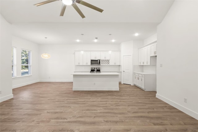 unfurnished living room with light hardwood / wood-style flooring and ceiling fan