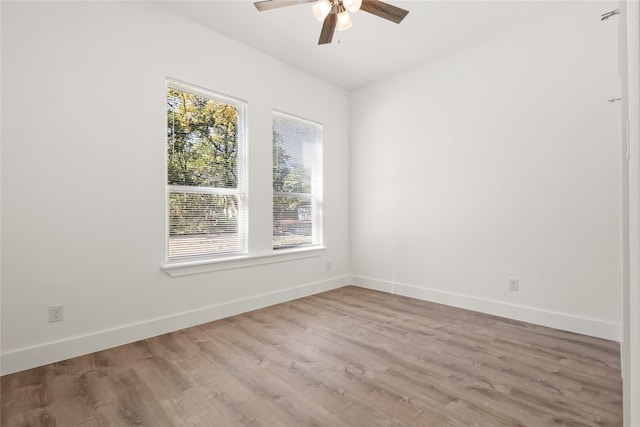 empty room with light hardwood / wood-style flooring and ceiling fan