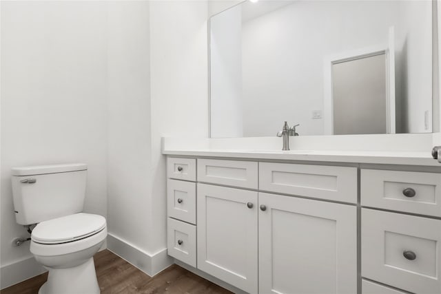 bathroom featuring hardwood / wood-style floors, vanity, and toilet