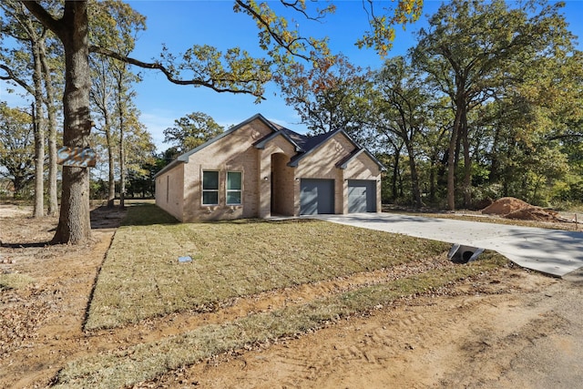 ranch-style home featuring a garage and a front yard