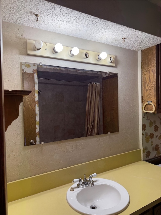 bathroom with vanity and a textured ceiling