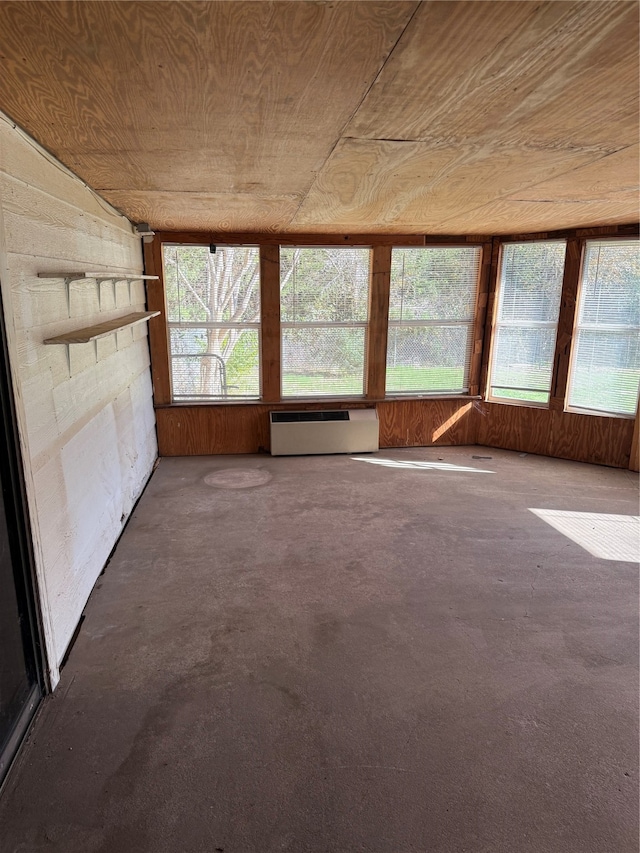 unfurnished sunroom with a wall mounted air conditioner and wooden ceiling