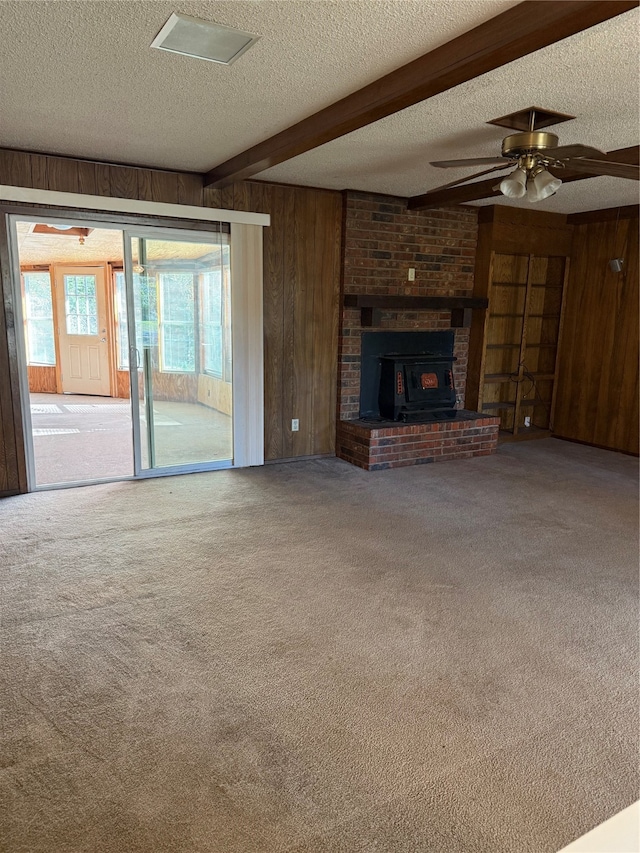 unfurnished living room featuring ceiling fan, carpet floors, and a textured ceiling