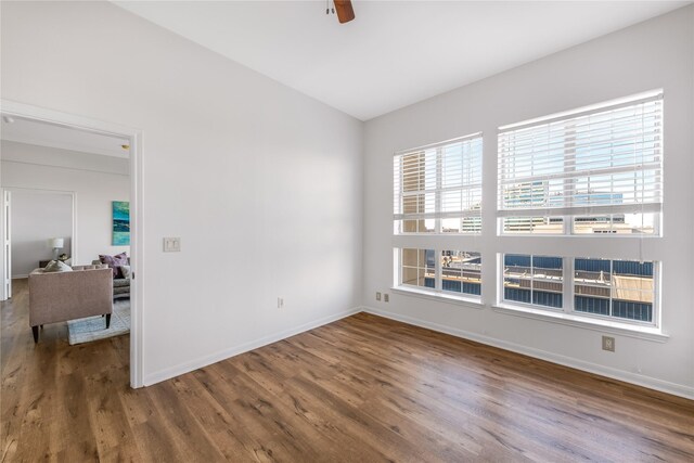 unfurnished room with dark hardwood / wood-style floors and ceiling fan