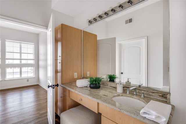 bathroom with hardwood / wood-style flooring and vanity