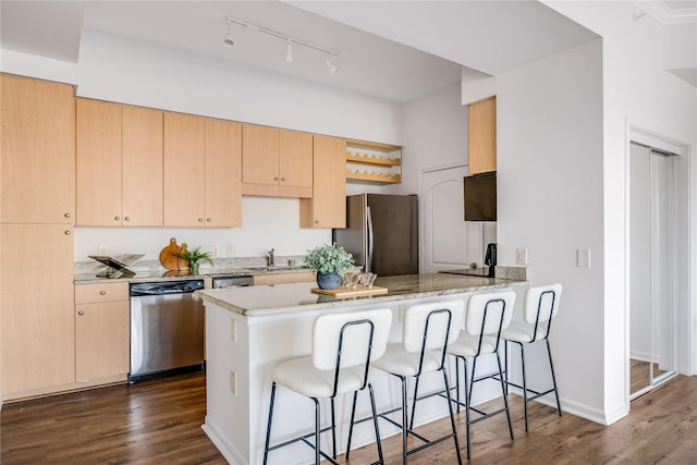 kitchen featuring light brown cabinetry, black fridge, dark hardwood / wood-style floors, dishwasher, and kitchen peninsula