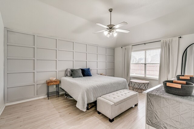 bedroom with vaulted ceiling, ceiling fan, and light hardwood / wood-style floors