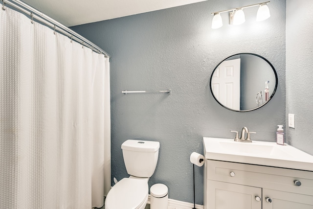 bathroom featuring toilet and vanity