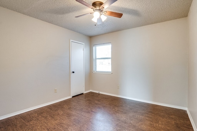 empty room featuring a textured ceiling, dark hardwood / wood-style flooring, and ceiling fan