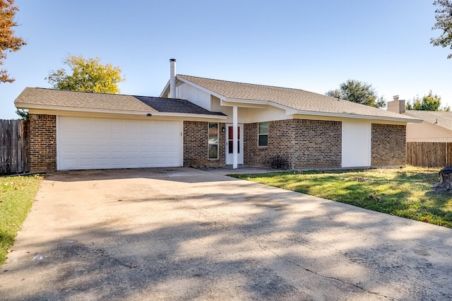 single story home with a garage and a front lawn