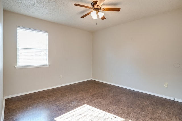 spare room with a textured ceiling, dark hardwood / wood-style floors, and ceiling fan