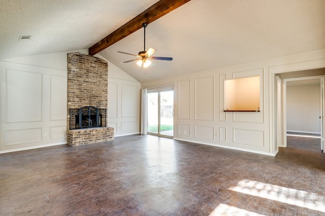 unfurnished living room featuring a brick fireplace, vaulted ceiling with beams, ceiling fan, dark hardwood / wood-style floors, and a textured ceiling