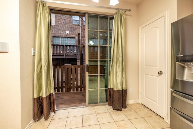 doorway to outside with light tile patterned floors