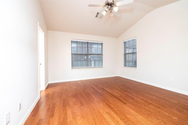 empty room with ceiling fan, light hardwood / wood-style floors, and lofted ceiling