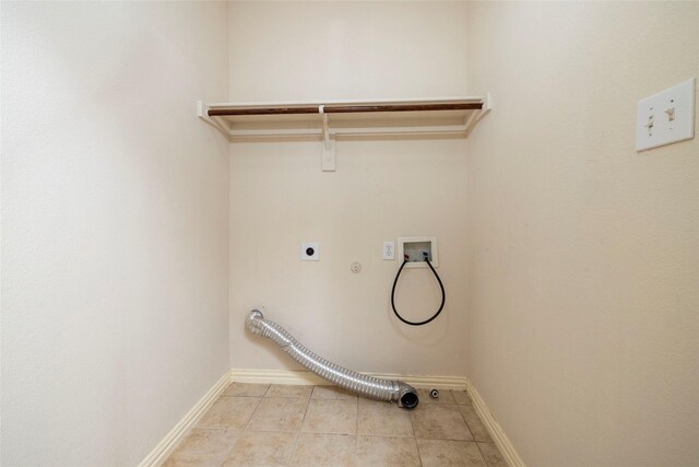 laundry area with hookup for an electric dryer, washer hookup, light tile patterned floors, and hookup for a gas dryer