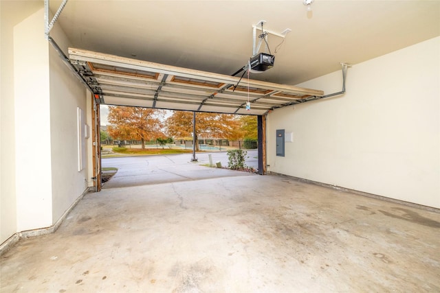 garage with a garage door opener and electric panel