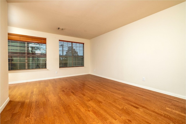 spare room featuring hardwood / wood-style flooring