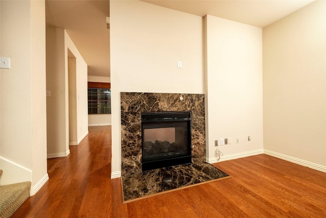 interior space featuring hardwood / wood-style floors and a multi sided fireplace