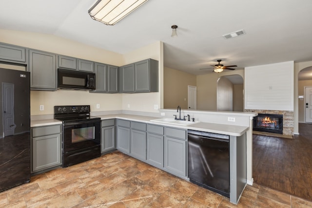 kitchen featuring gray cabinets, sink, kitchen peninsula, and black appliances