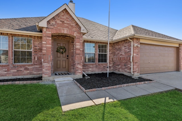 ranch-style house featuring a garage and a front lawn