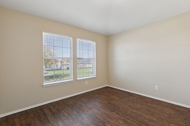 unfurnished room with dark hardwood / wood-style flooring