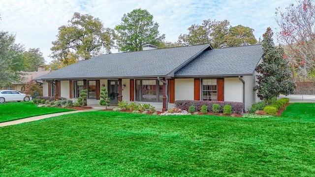 ranch-style house with a garage and a front yard