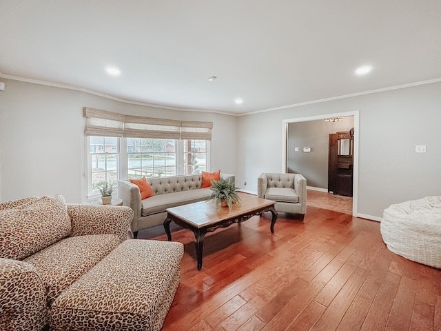 living room with hardwood / wood-style flooring and crown molding