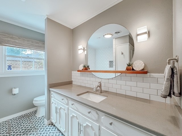 bathroom featuring tasteful backsplash, tile patterned floors, ornamental molding, vanity, and toilet