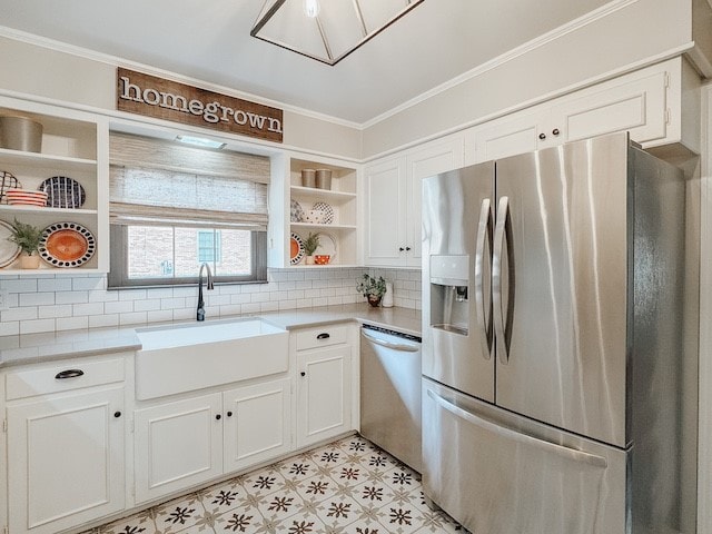 kitchen featuring backsplash, stainless steel appliances, crown molding, sink, and white cabinetry