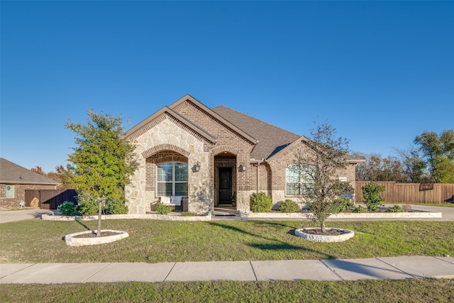 french provincial home with a front lawn