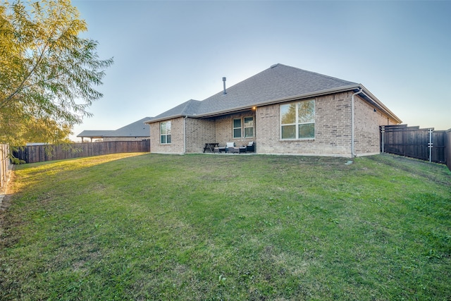 rear view of house with a yard