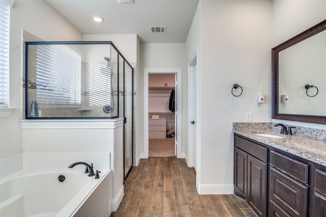 bathroom with vanity, shower with separate bathtub, and hardwood / wood-style flooring