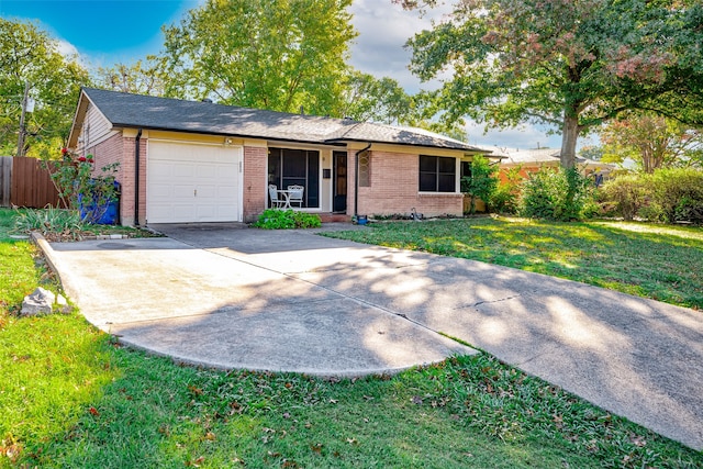 single story home with a garage and a front lawn