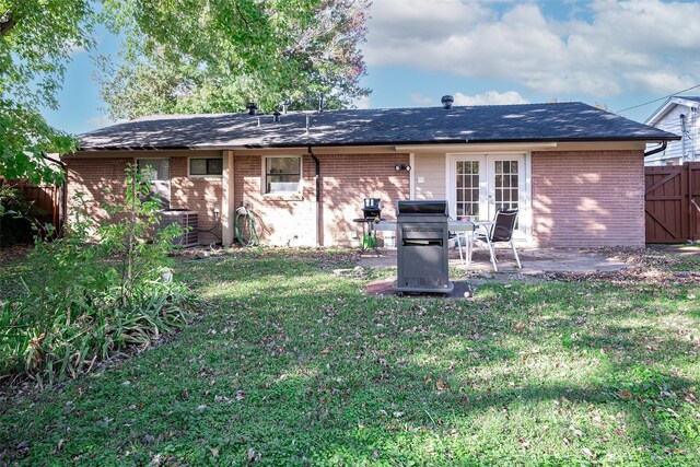 back of house featuring a yard, central AC, french doors, and a patio area