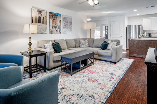 living room with dark wood-type flooring, french doors, and ceiling fan